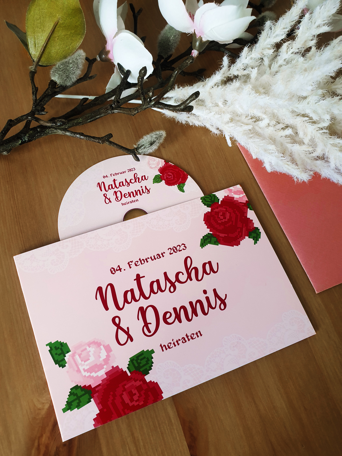 pink wedding invitation for Natascha and Dennis with pixelates roses for a retro gaming look and feel