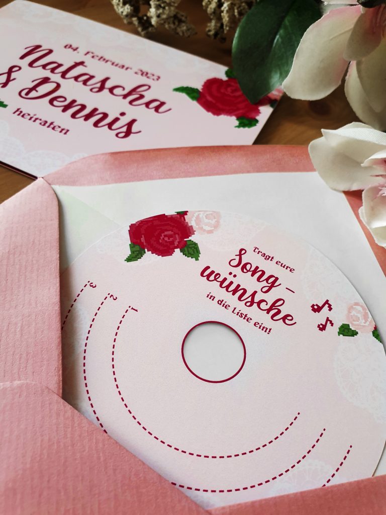 round paper card with cutout in the middle to look like a CD for song wishes at the wedding