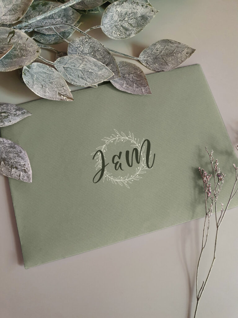 sage green envelope with the wedding logo
